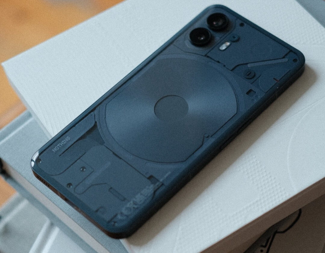 The Nothing Phone 2 sitting on top of its cardboard packaging