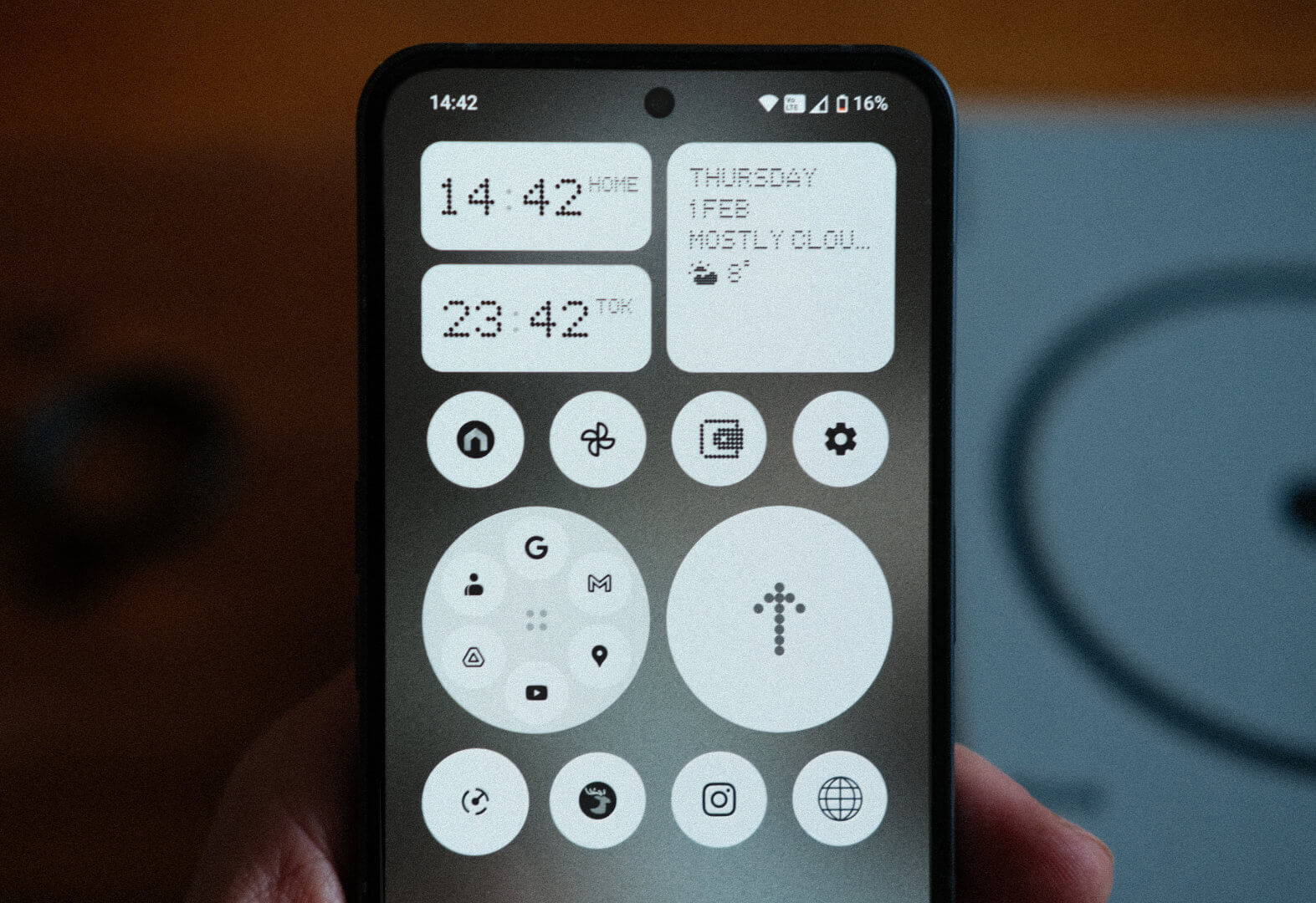 The Nothing OS home screen, showing the minimal, greyscale aesthetic